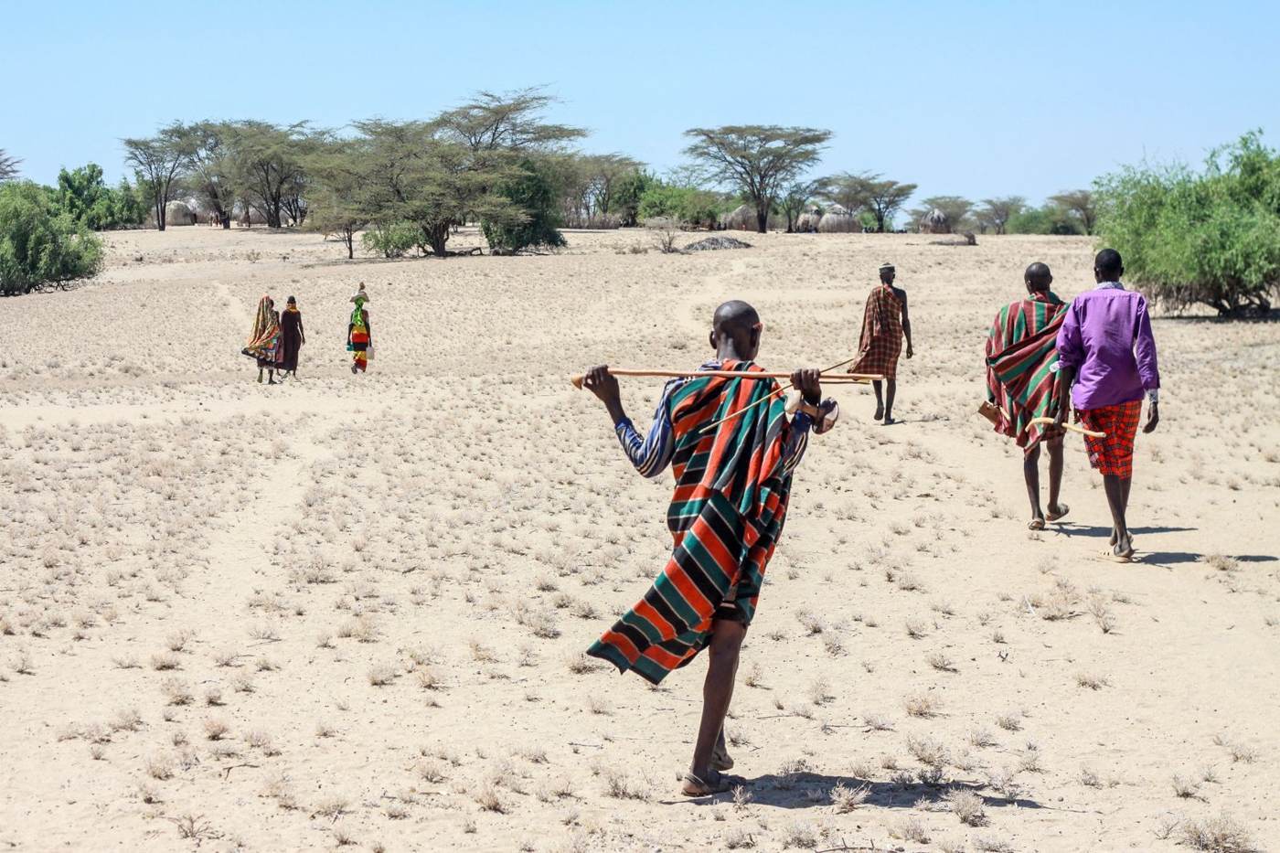 Turkana herders walking across open land